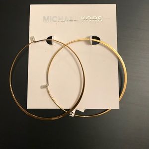 Michael Kors golden hoop earrings.